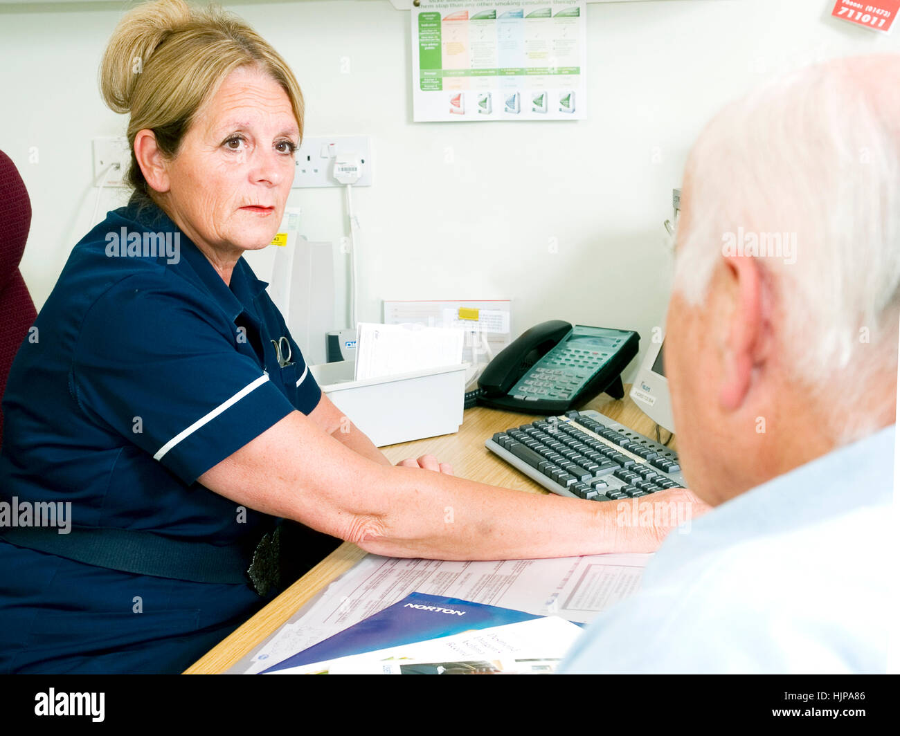 Nurse talking to patient regarding blood test results at appointment at local GP health clinic Stock Photo