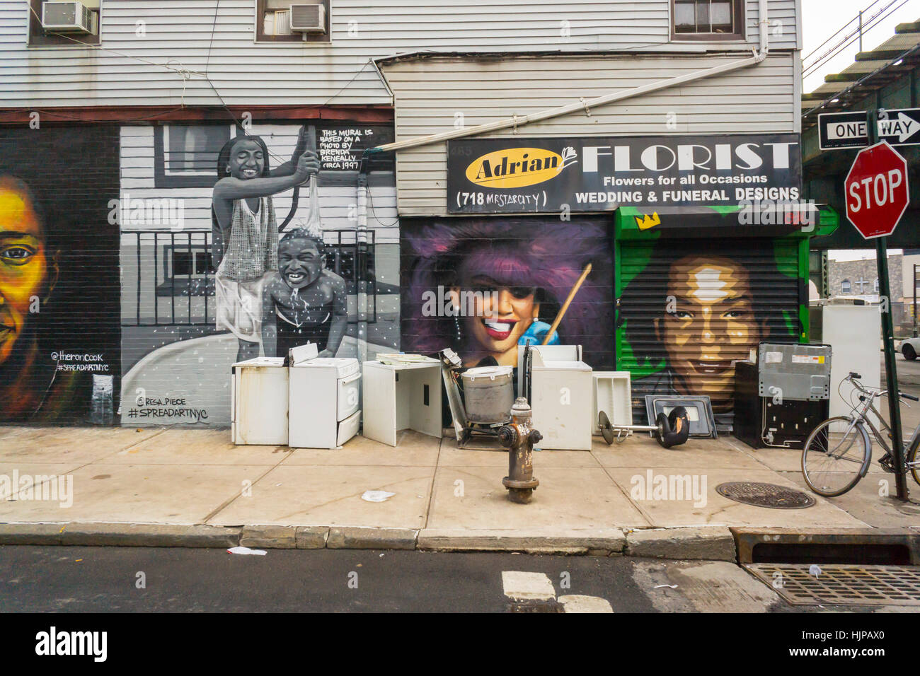 Murals and used appliances in various states of disrepair in the