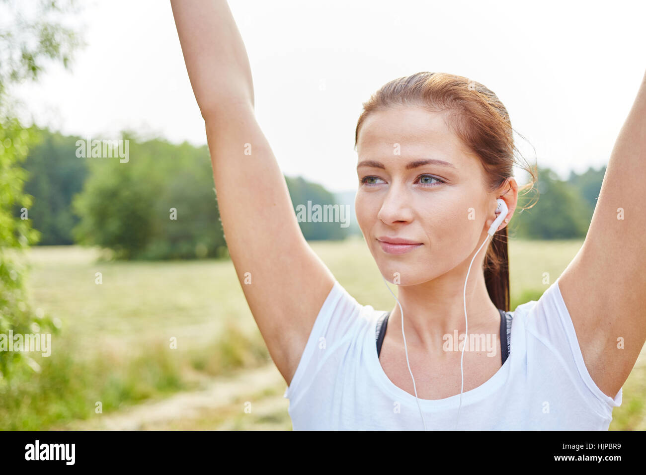Young woman stretching her arms for relaxation Stock Photo