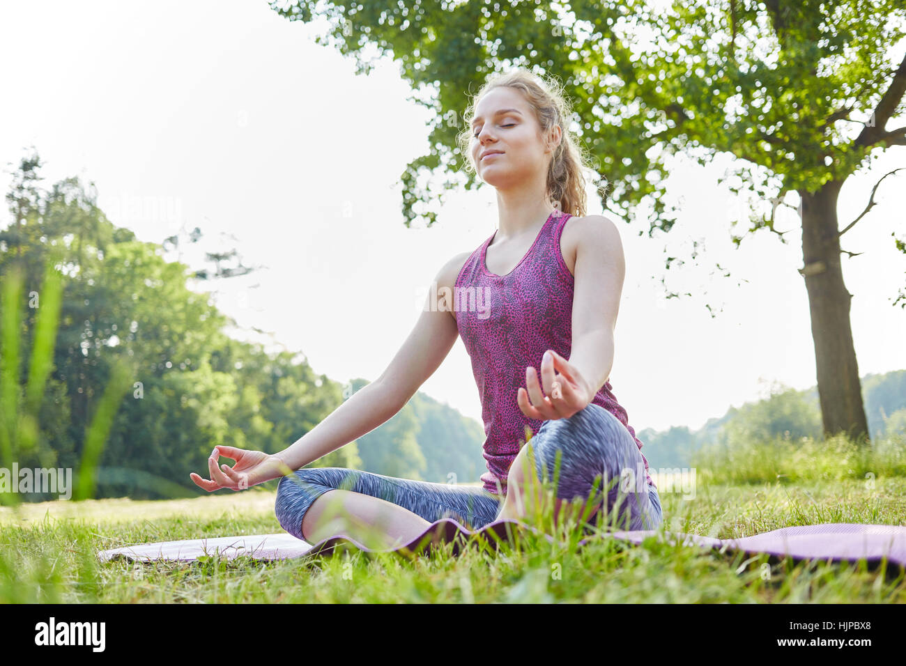 Young woman breathing deeply and making yoga exercise Stock Photo Alamy