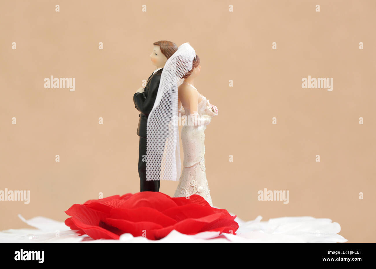 A divorced couple on top of a wedding cake Stock Photo