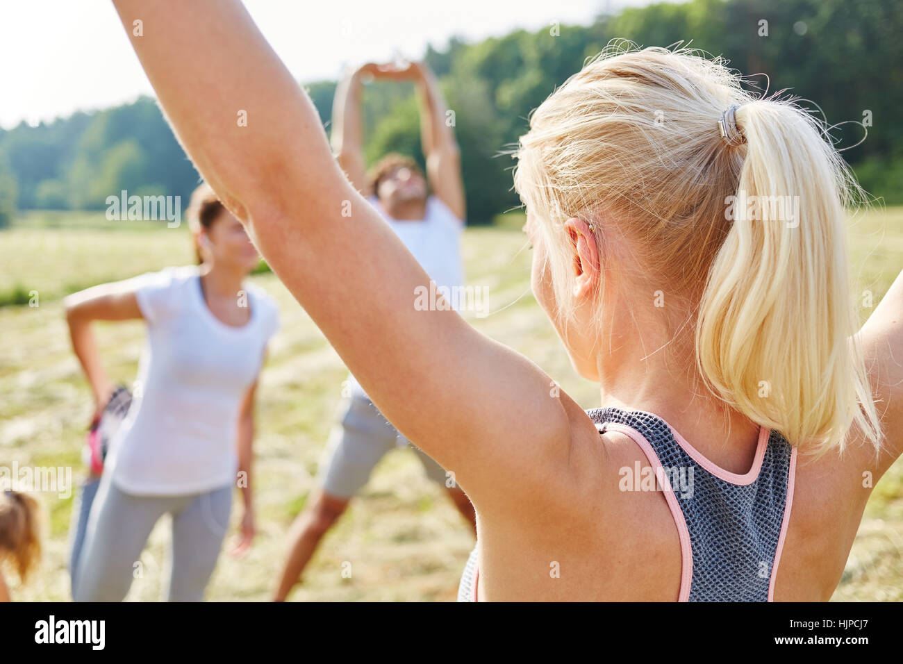 Young people stretching in health class making sport Stock Photo
