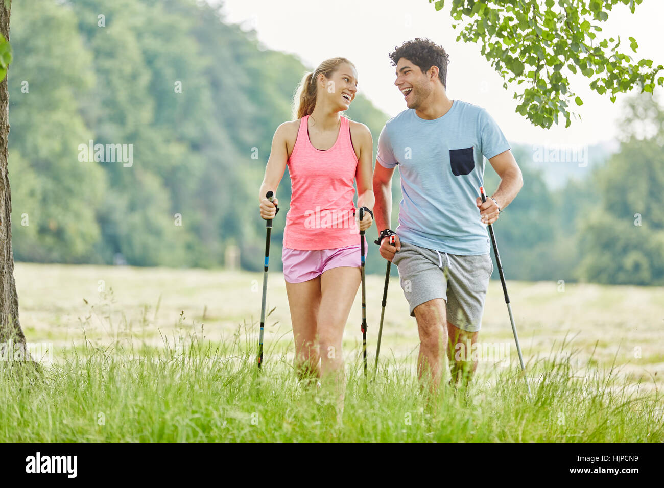 Couple having fun while nordic walking in the park Stock Photo