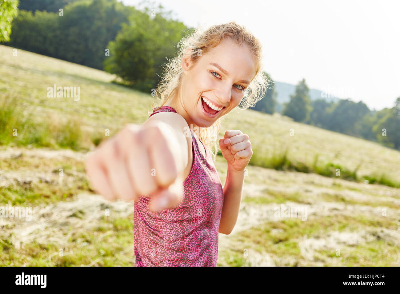 Vitale woman practicing box and clenching a fist Stock Photo