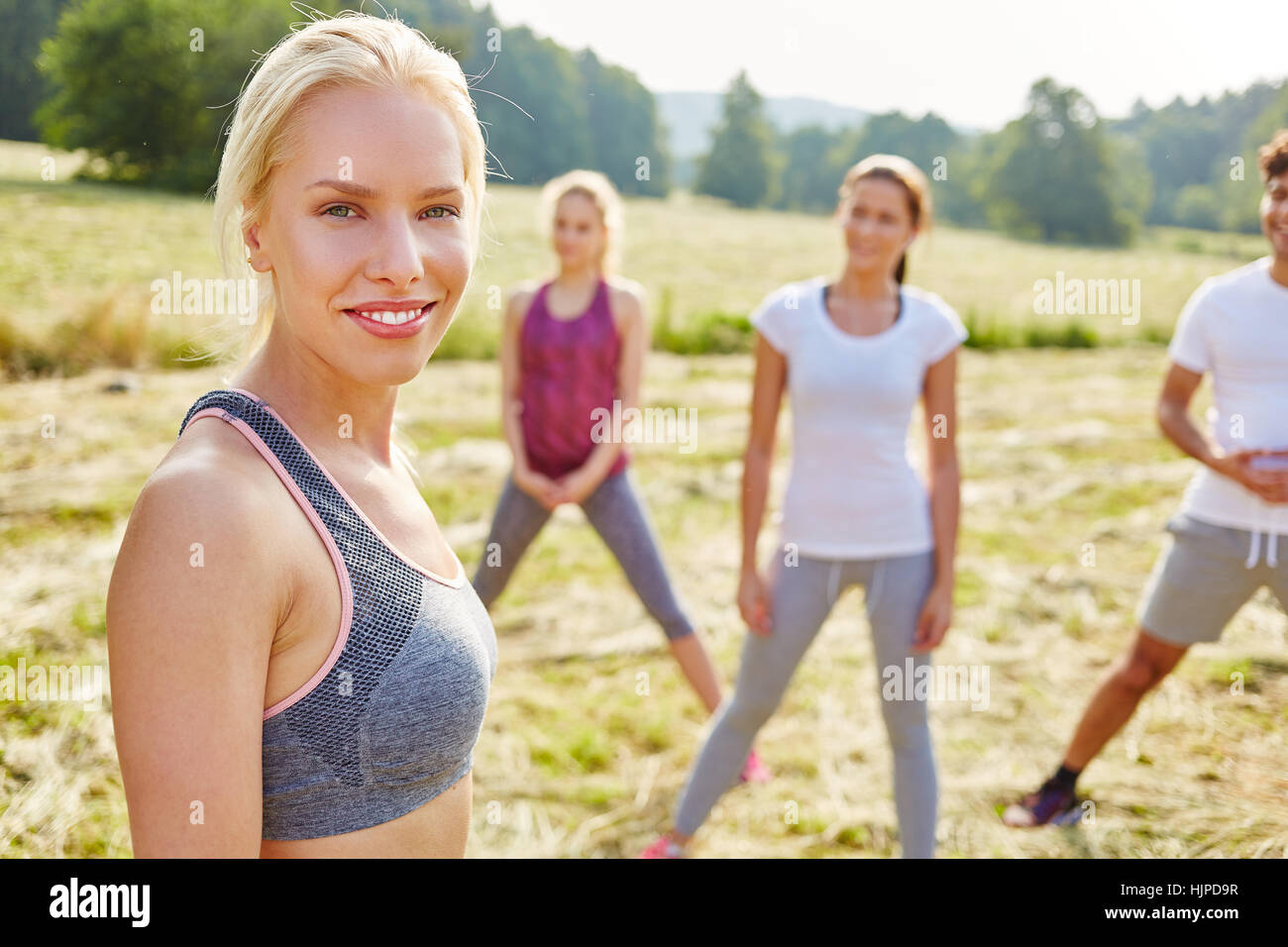 Woman as aerobics coach at class in the park Stock Photo