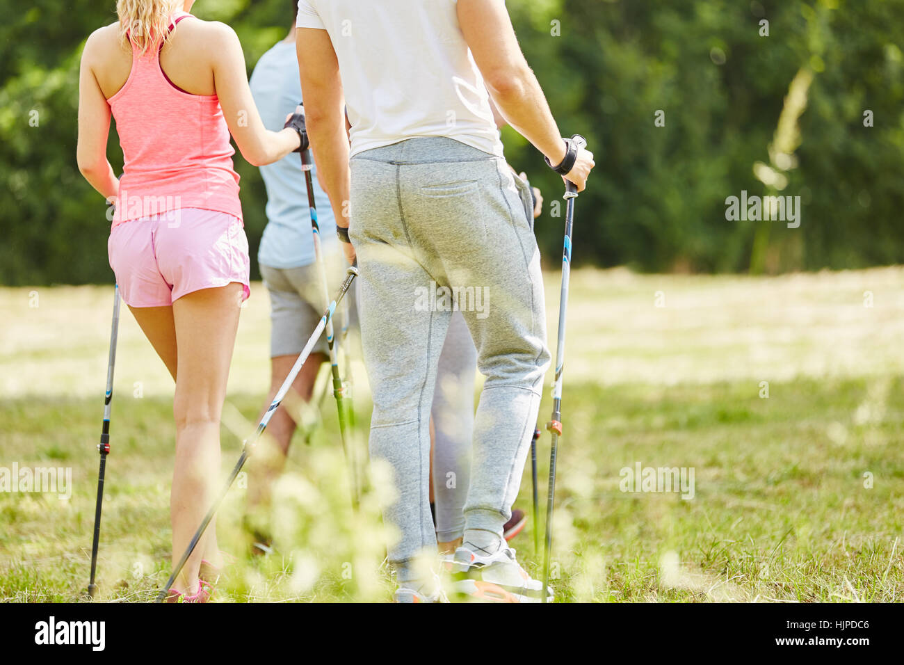 Hiking trip with hiking sticks their summer holiday vacation time Stock Photo