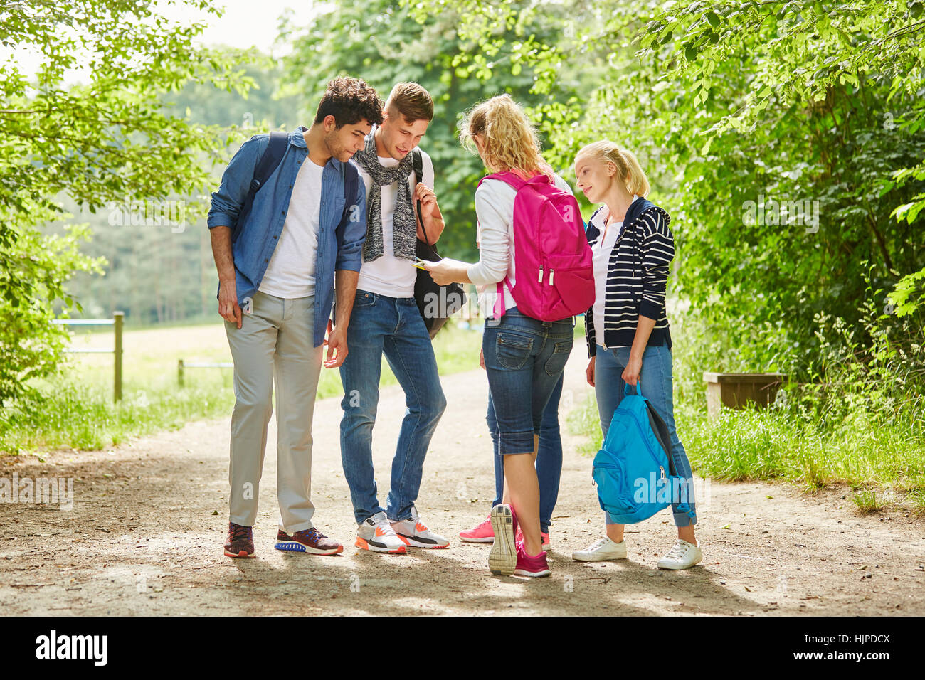 Group of young people hiking and finding the right trail Stock Photo ...
