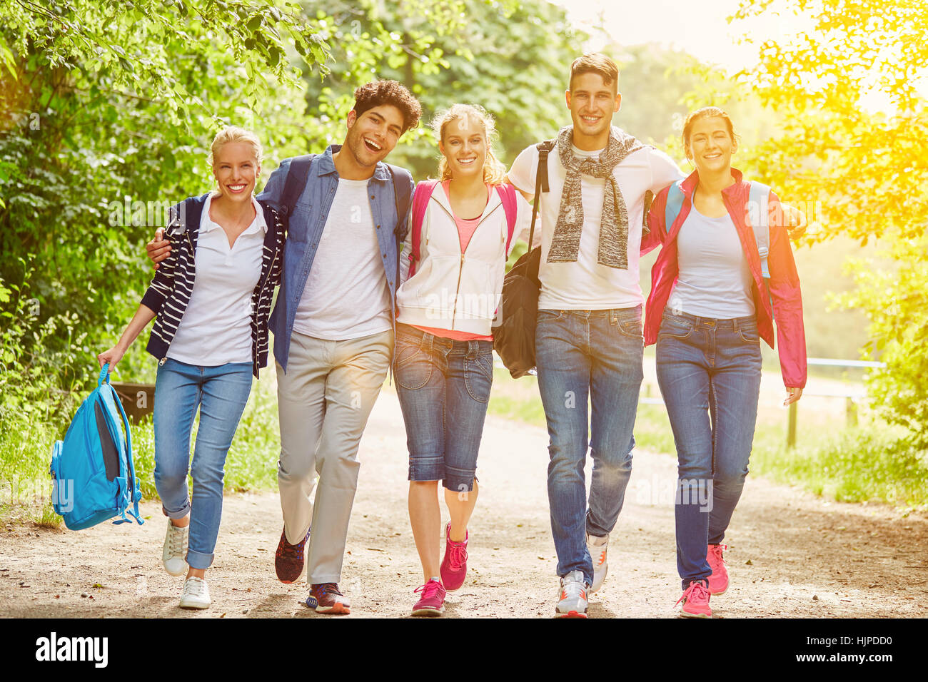 Group of teenagers as friends having fun in the nature in summer Stock Photo