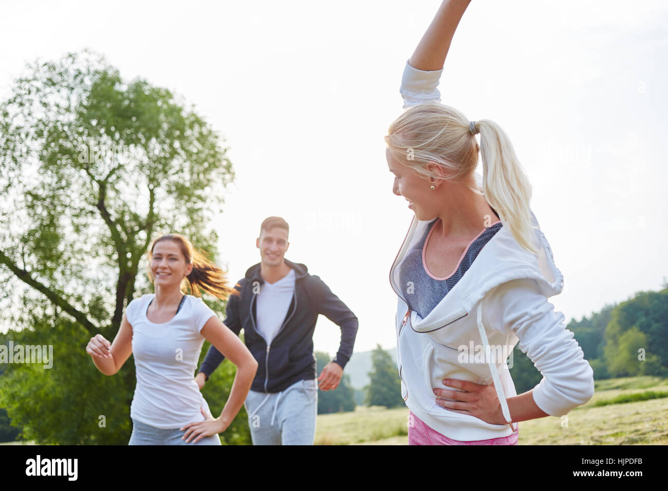 Group of active people making fitness training exercises Stock Photo