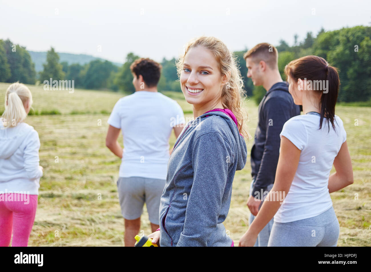 Sporty woman with friends after making sport in the nature Stock Photo