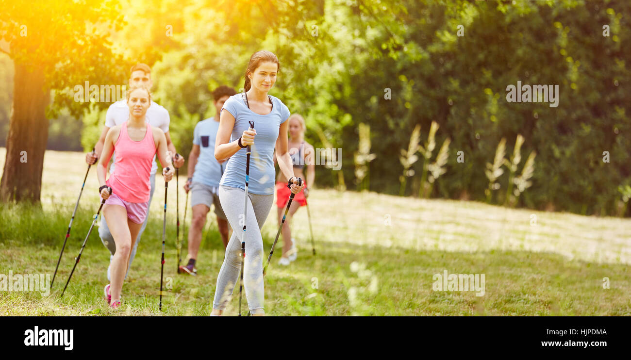 Nordic walking group hiking in summer Stock Photo Alamy