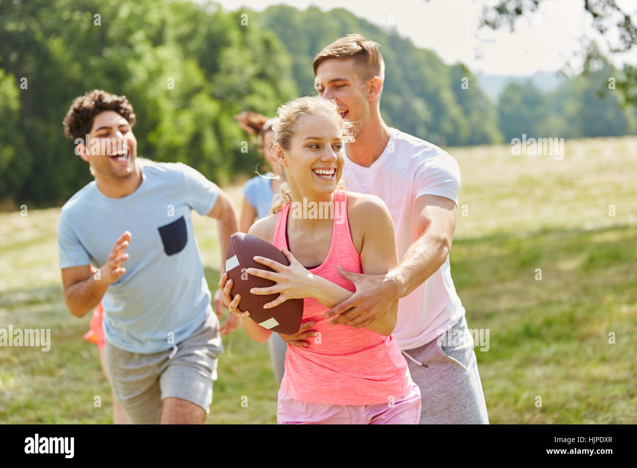 Woman playing rugby with friends for sport practice class Stock Photo ...
