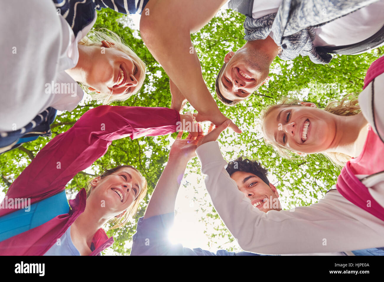Students giving each other a High Five as symbol of togetherness Stock Photo