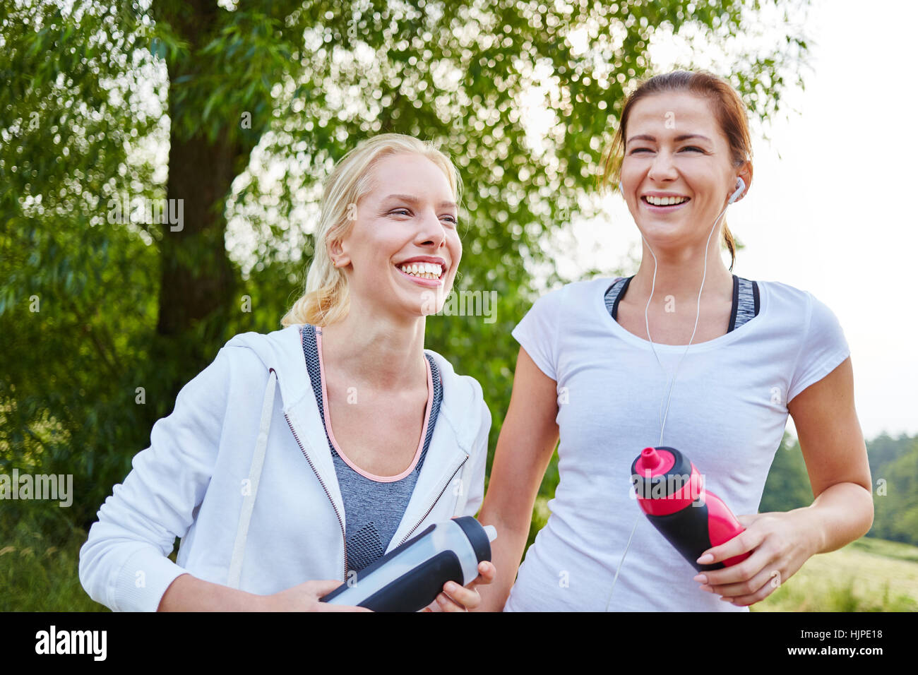 Two sporty women laughing after fitness training Stock Photo