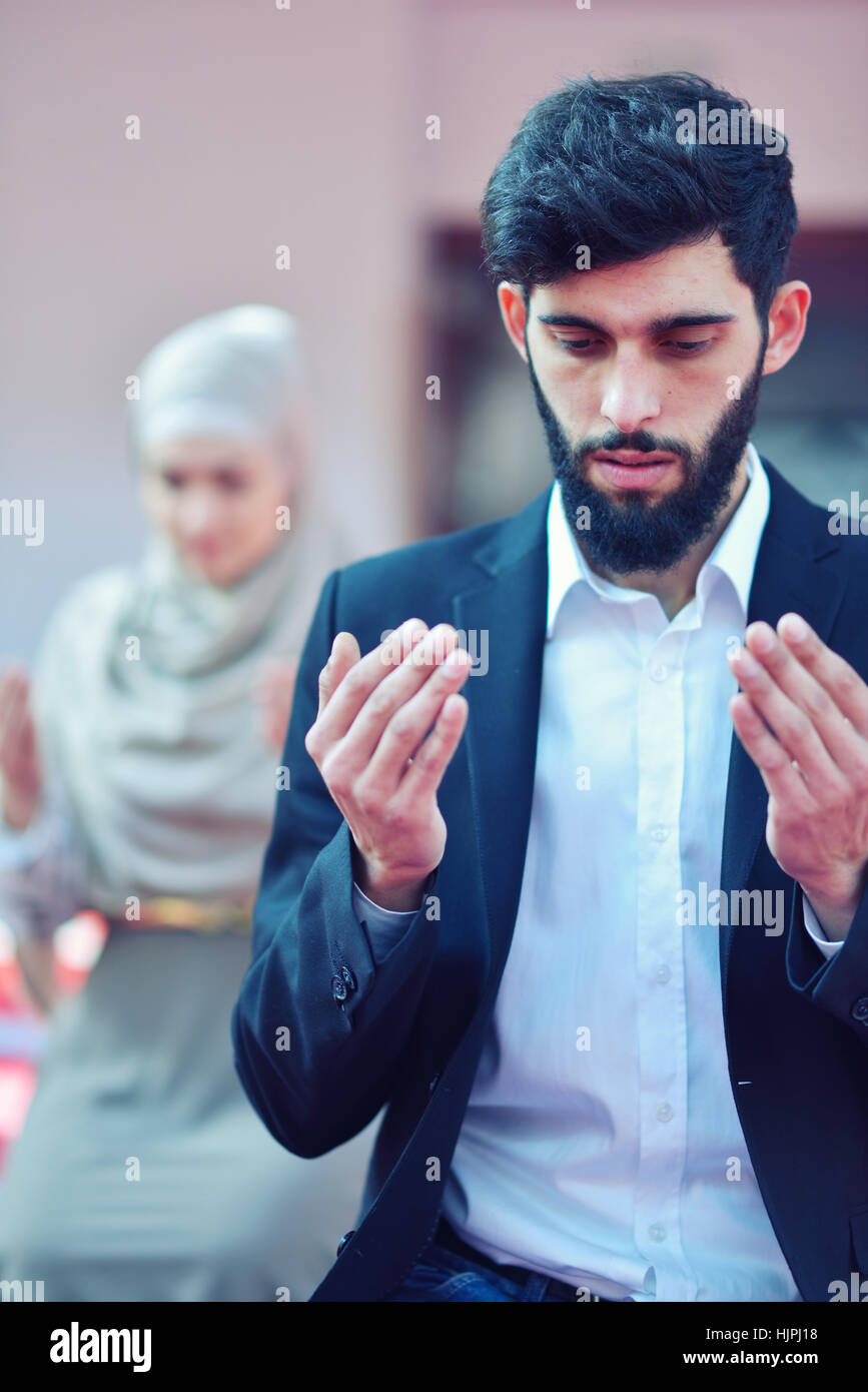 Muslim man and woman praying in mosque Stock Photo Alamy