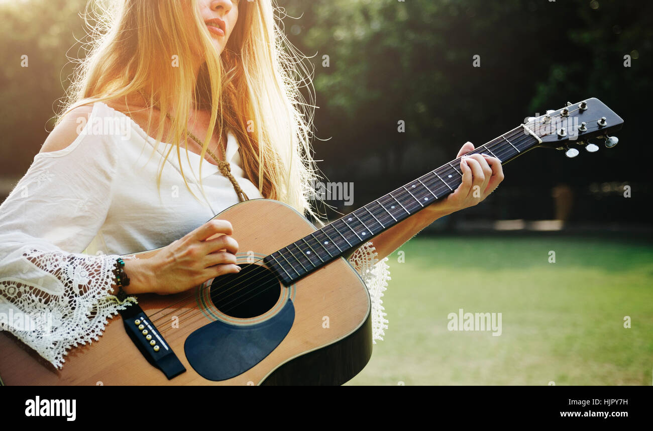 Blonde Girl Playing Guitar In The Park Concept Stock Photo - Alamy