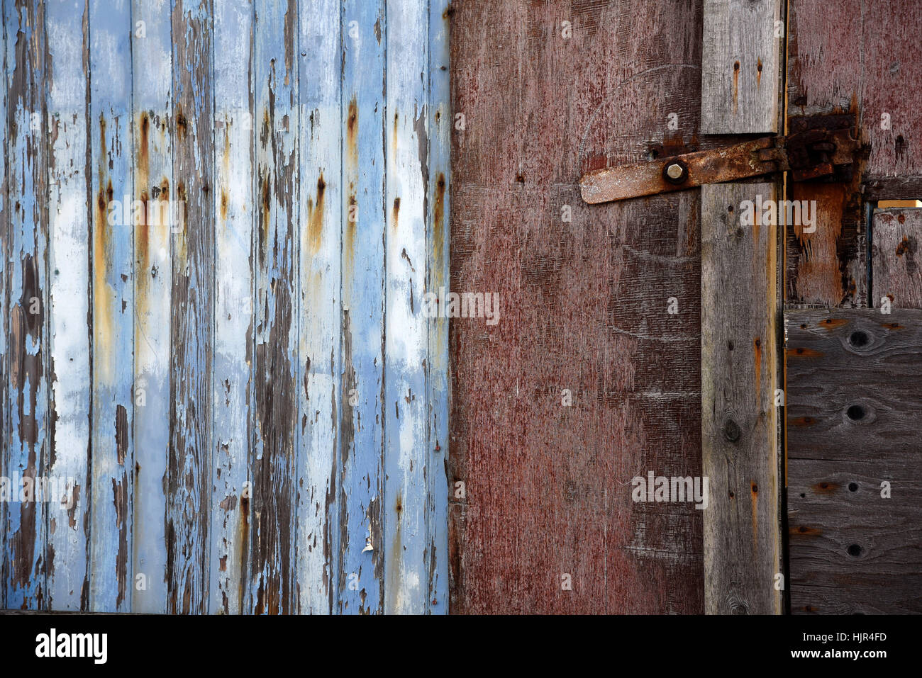 Colourful blue door with flaky paint and rusty lock Stock Photo