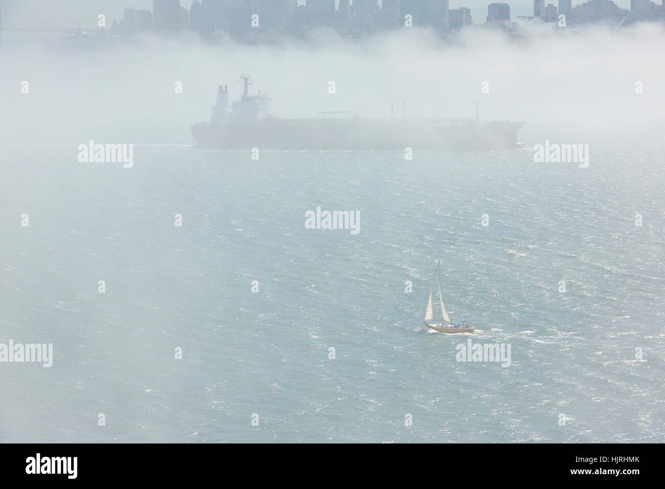 Large Cargo Ship Leaving San Francisco In Thick Fog. Stock Photo