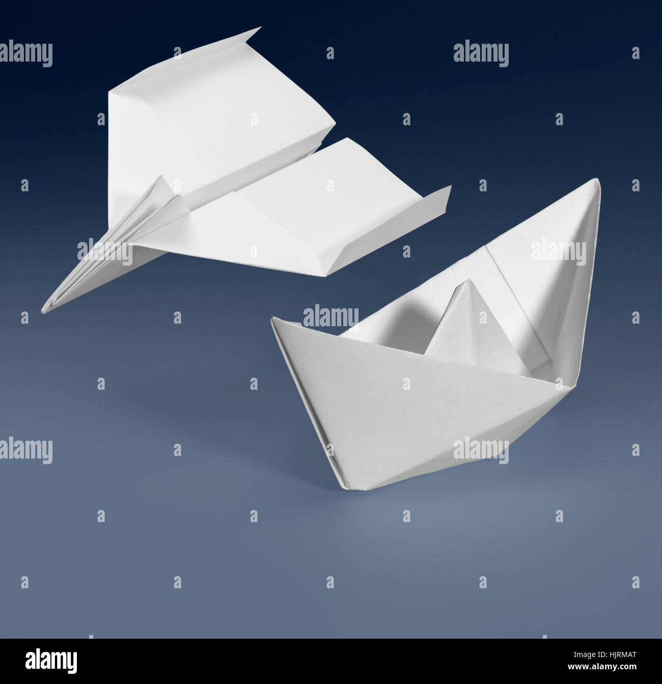 white paper ship and paper plane in blue gradient back Stock Photo
