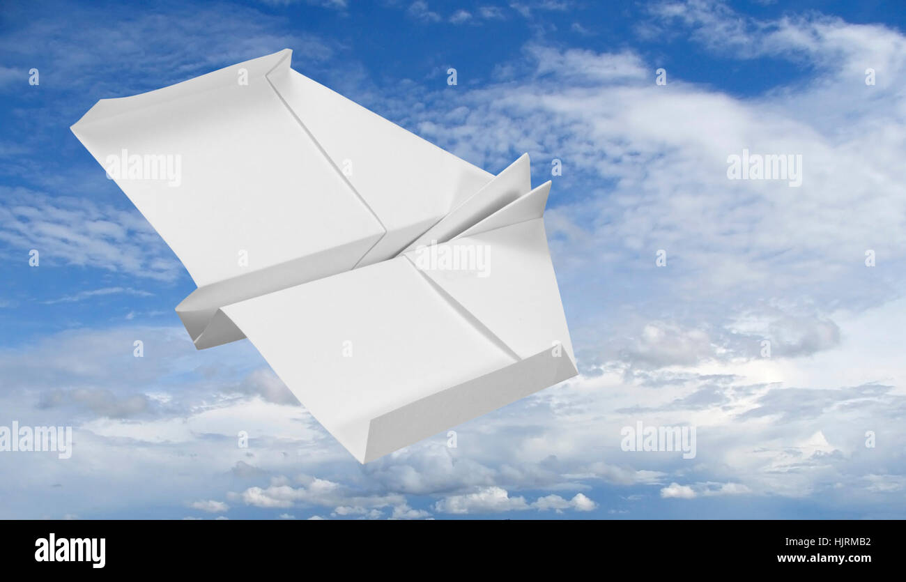white paper plane flying in the sky Stock Photo
