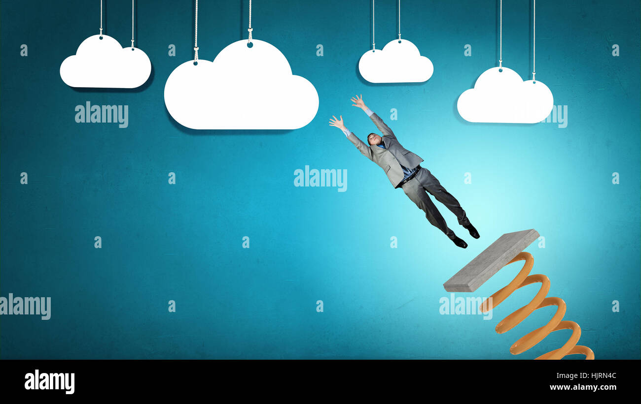 Businessman jumping on springboard as progress concept Stock Photo - Alamy
