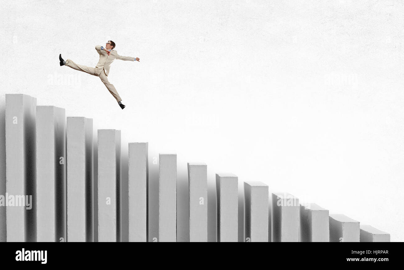 Young businessman running up on staircase representing success concept ...