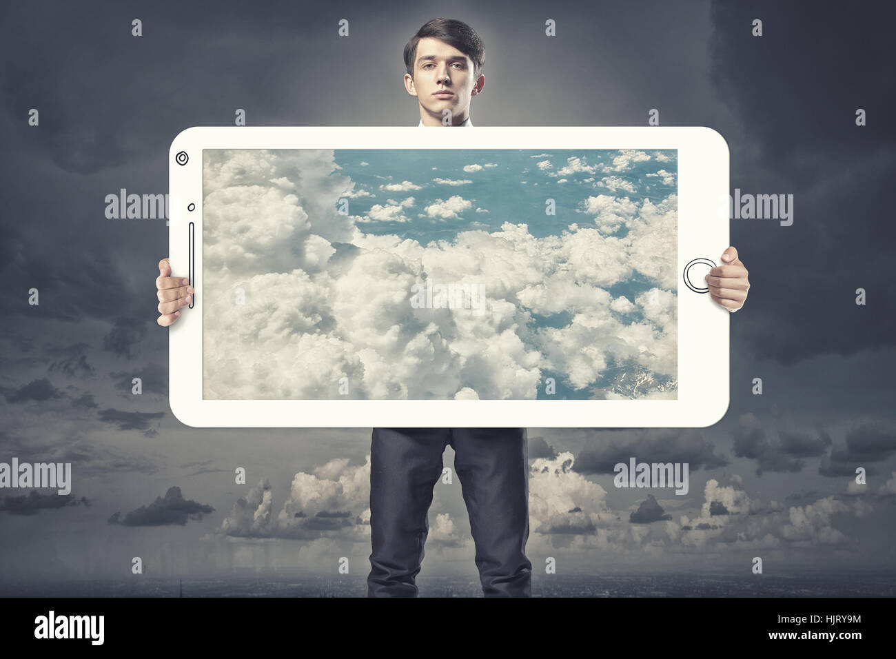 Young businessman holding banner with blue cloudy sky Stock Photo - Alamy