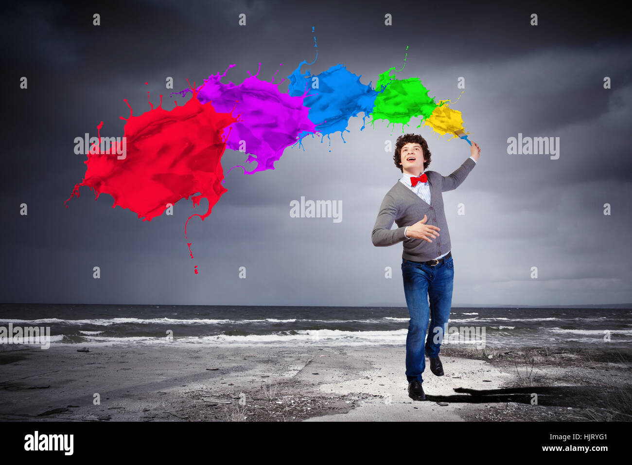 Young man with a splash coloured like a rainbow Stock Photo - Alamy