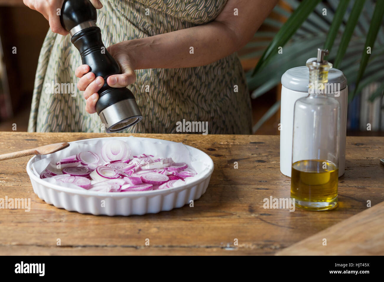 Woman preparing red onions for onion pesto Stock Photo Alamy