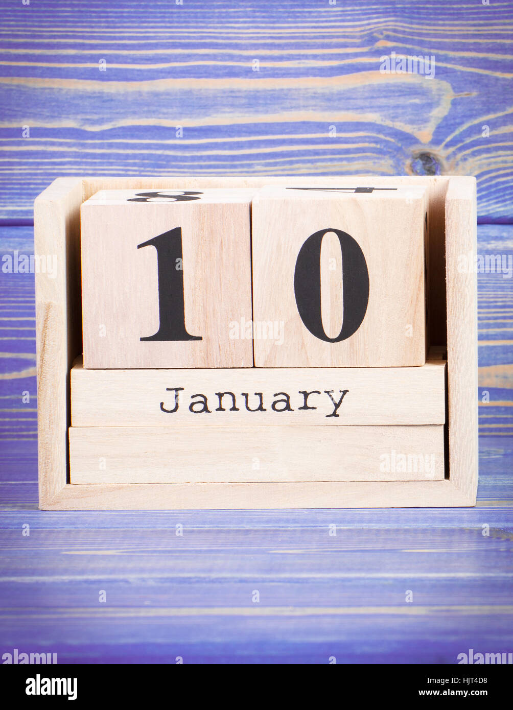 January 10th. Date of 10 January on wooden cube calendar, purple board as background Stock Photo