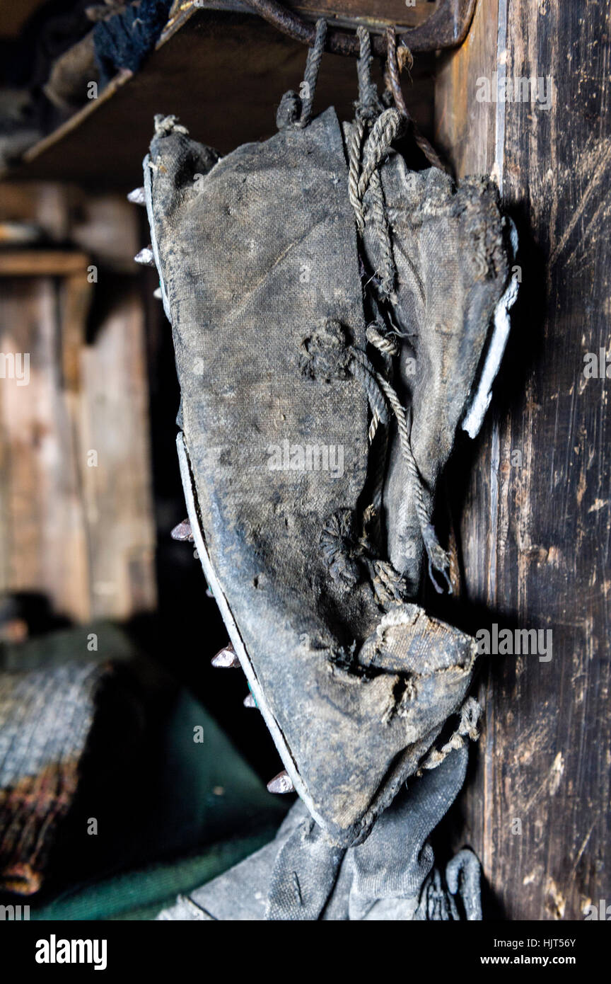 A leather boot hangs by its laces in the hut of Antarctic explorer Robert Falcon Scott. Stock Photo