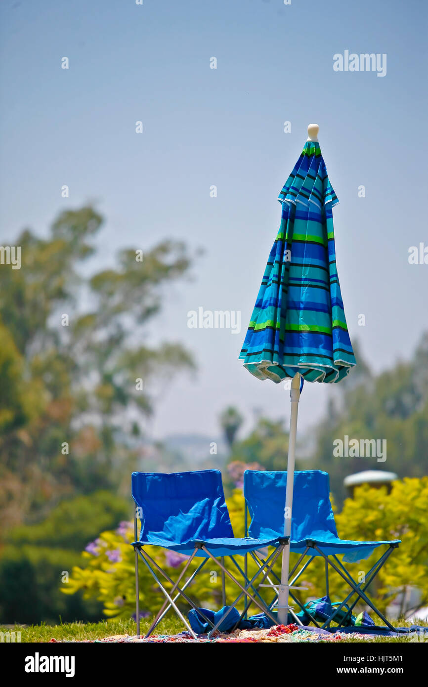 Umbrellla And Empty Blue Lawn Chairs At The Scottish Highland Games