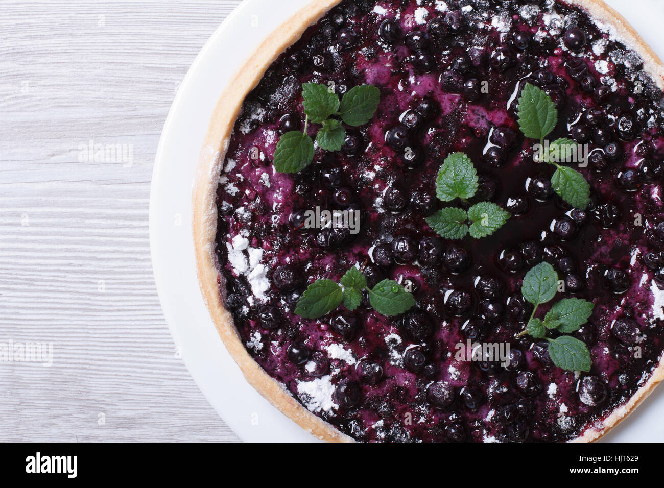 blueberry pie with mint on wooden background. top view horizontal closeup Stock Photo