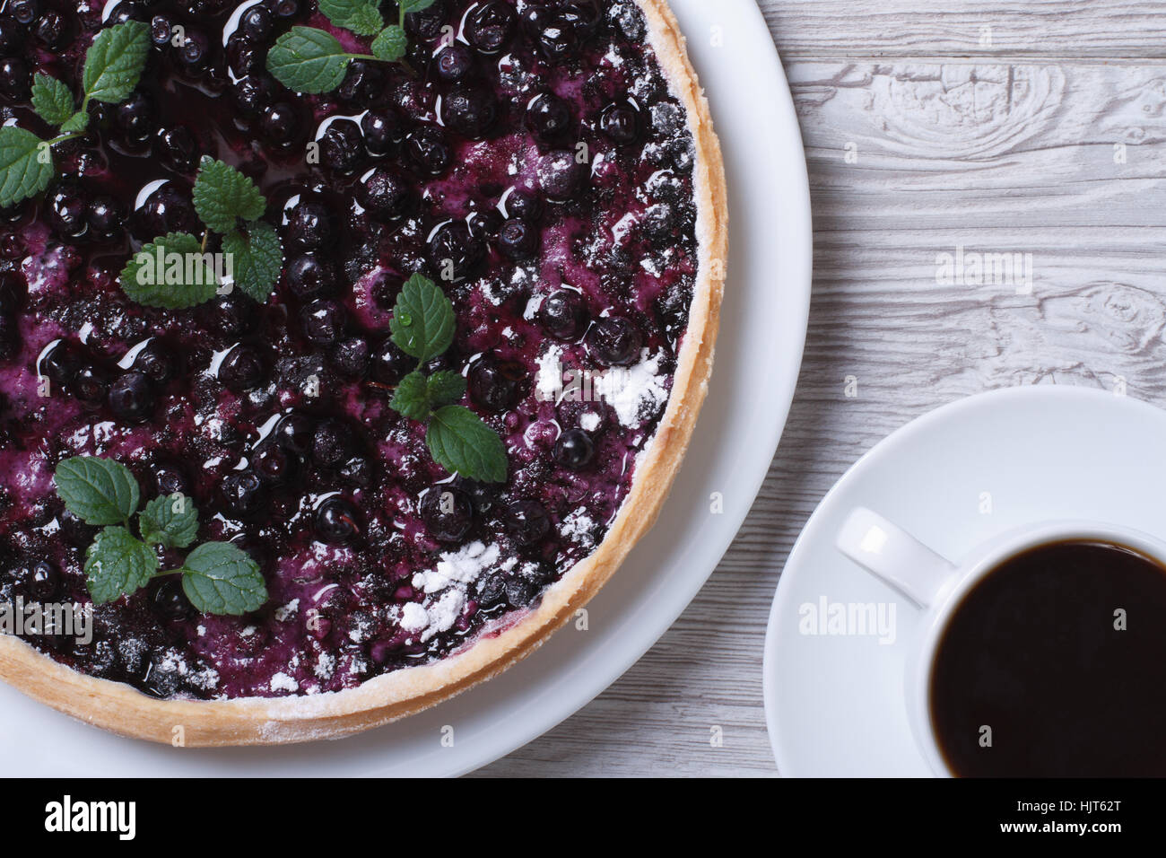 blueberry pie with mint and black coffee on a wooden background. top view horizontal closeup Stock Photo