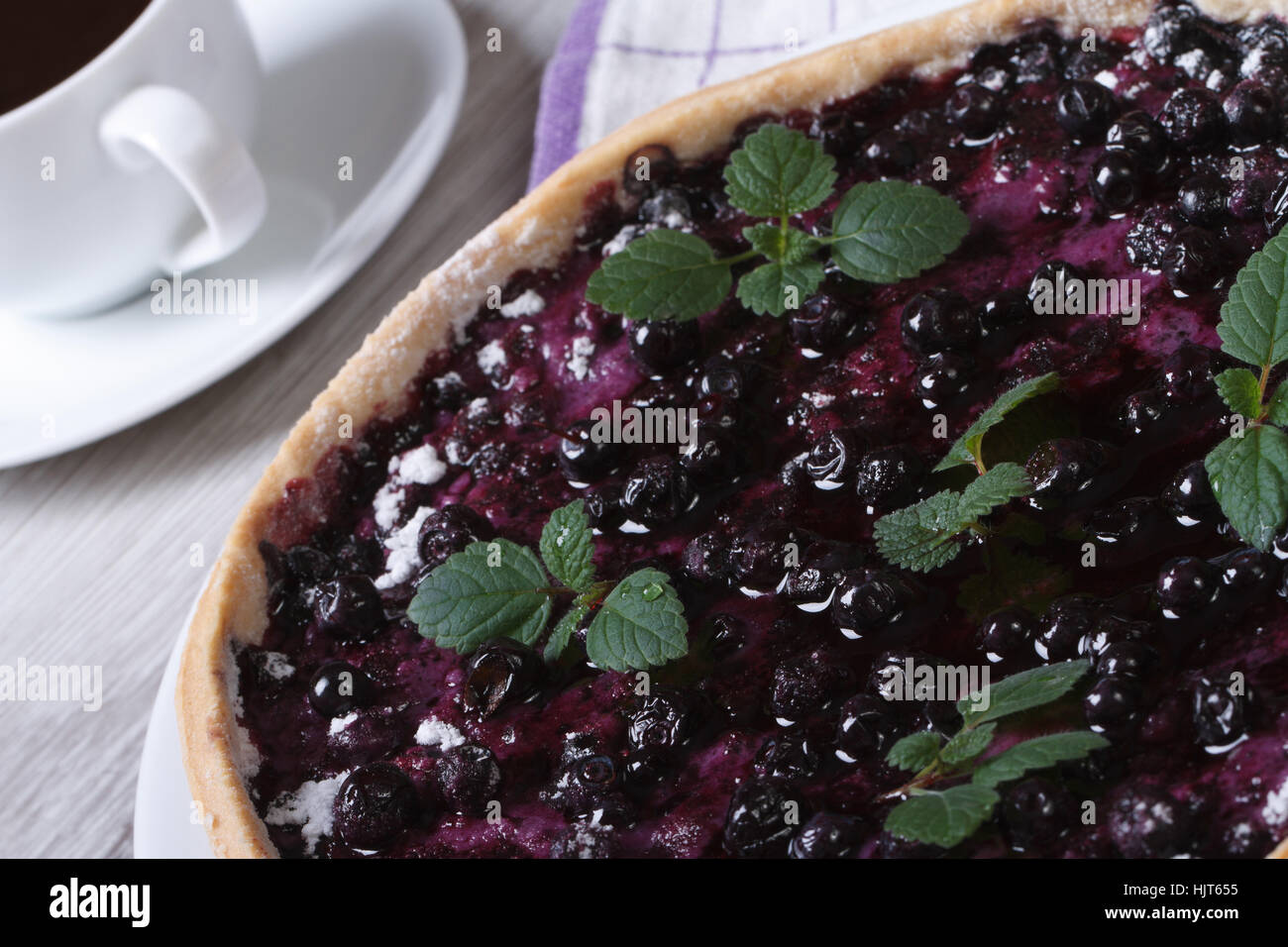 blueberry pie with mint and black coffee on a wooden table horizontal macro Stock Photo
