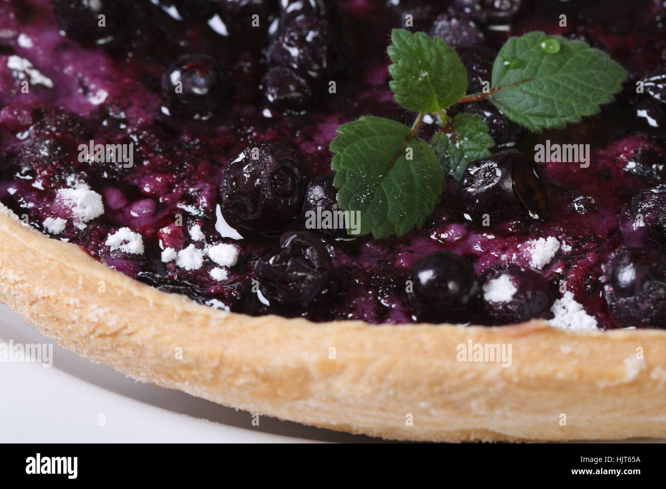 delicious blueberry pie with mint on a white plate macro horizontal Stock Photo
