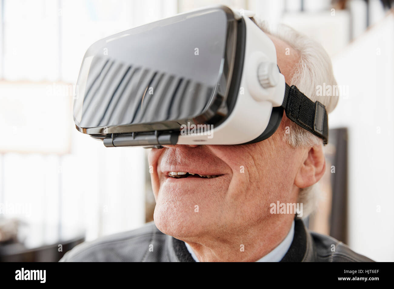 Senior man wearing VR glasses Stock Photo