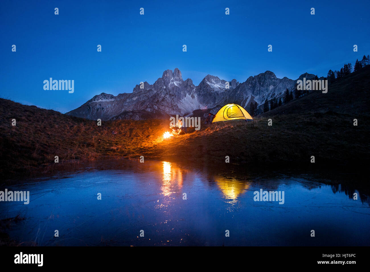 Austria, Salzburg State, Filzmoos, senior man camping in front of Mount Bischofsmutze Stock Photo