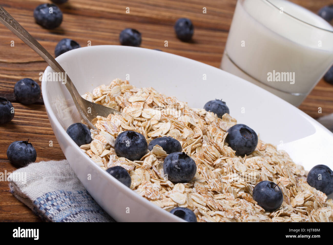 oatmeal with blueberries and milk in a glass on the table closeup horizontal Stock Photo