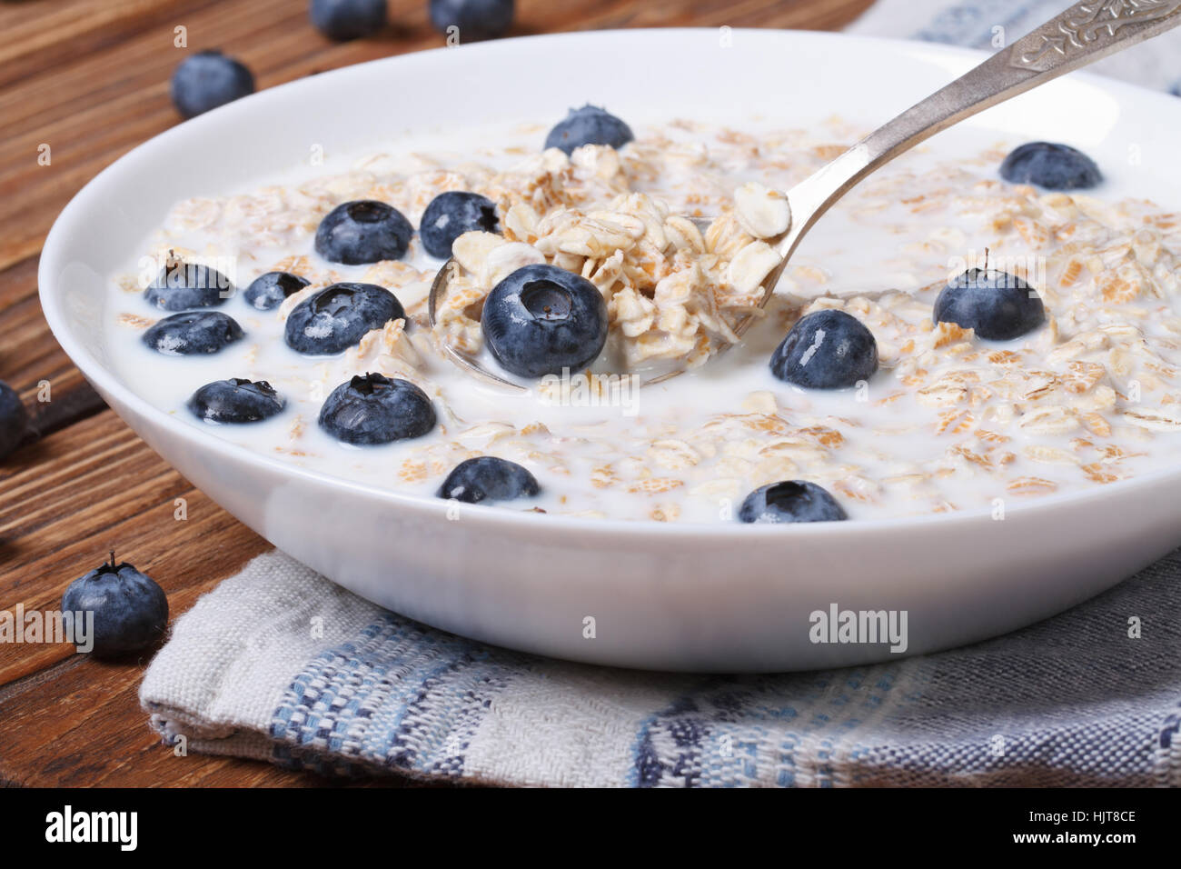 Tasty breakfast of oatmeal with blueberries and milk close up horizontal Stock Photo