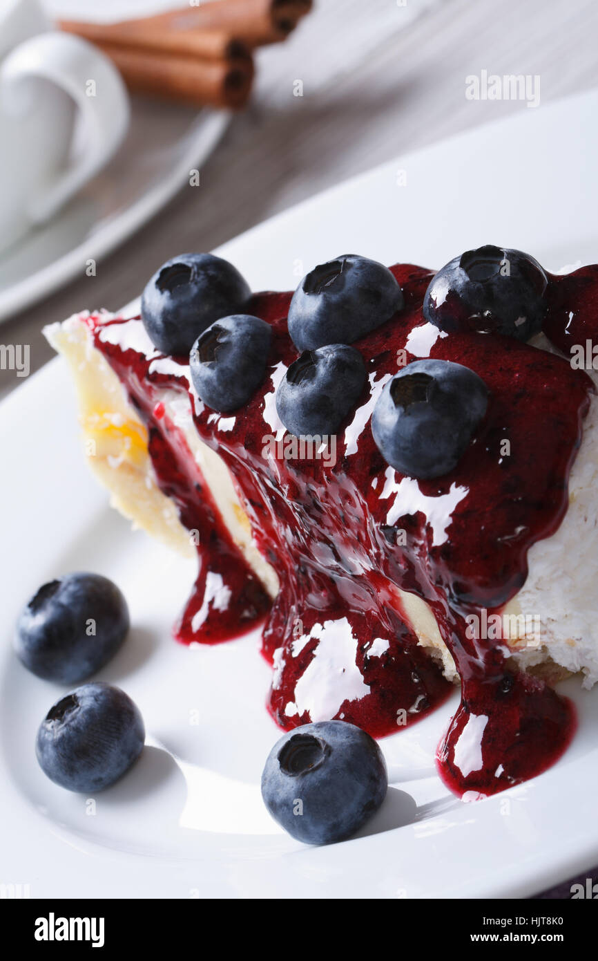 Blueberry cheesecake with berry sauce on a plate close up vertical Stock Photo