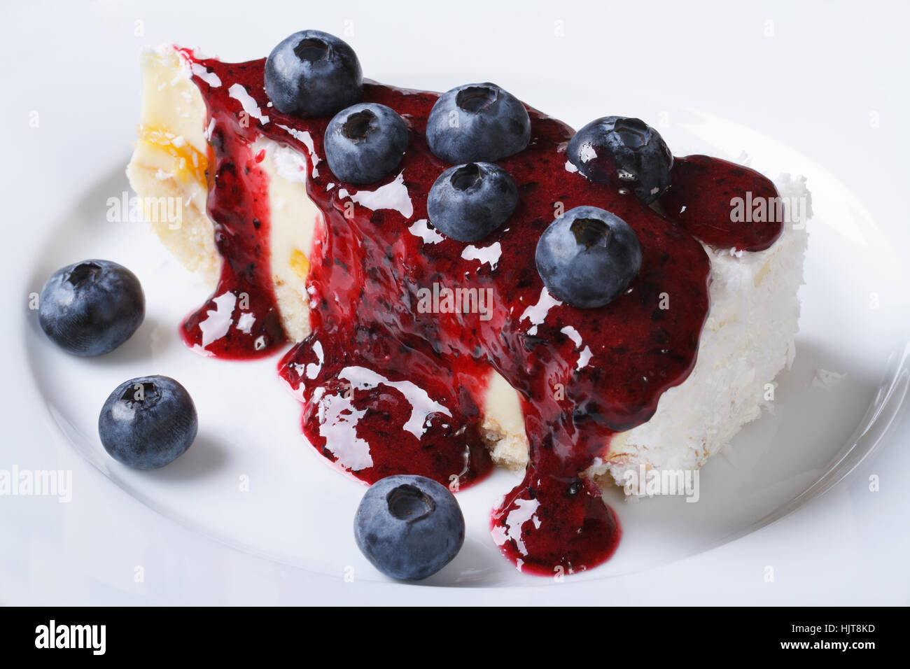 Blueberry cheesecake with berry sauce on the plate closeup horizontal top view Stock Photo
