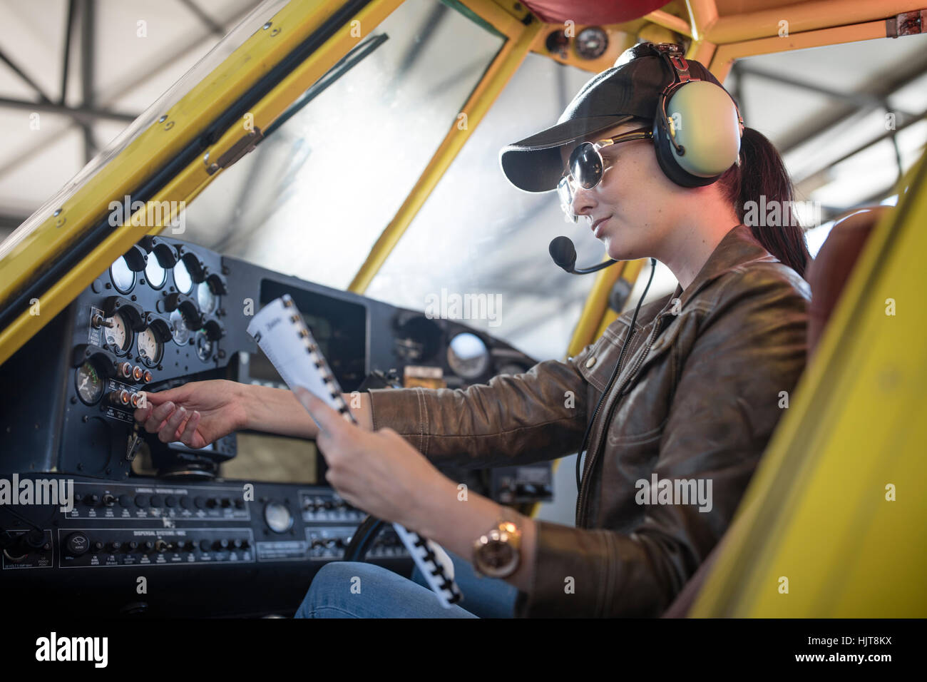 Female pilot inspecting light aircraft cockpit Stock Photo