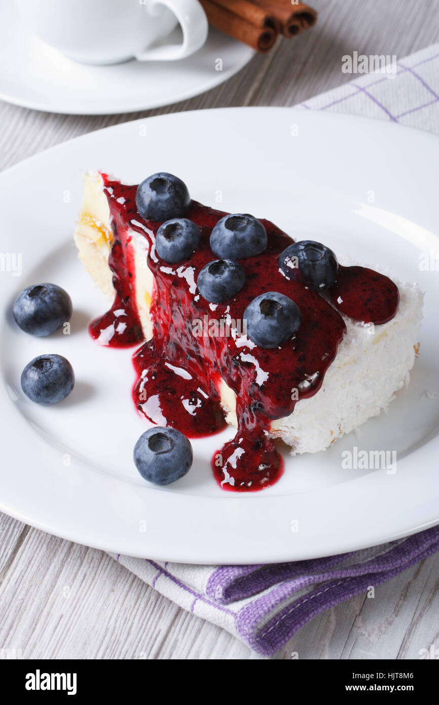 Blueberry cheesecake with berry sauce closeup on table top view vertical Stock Photo