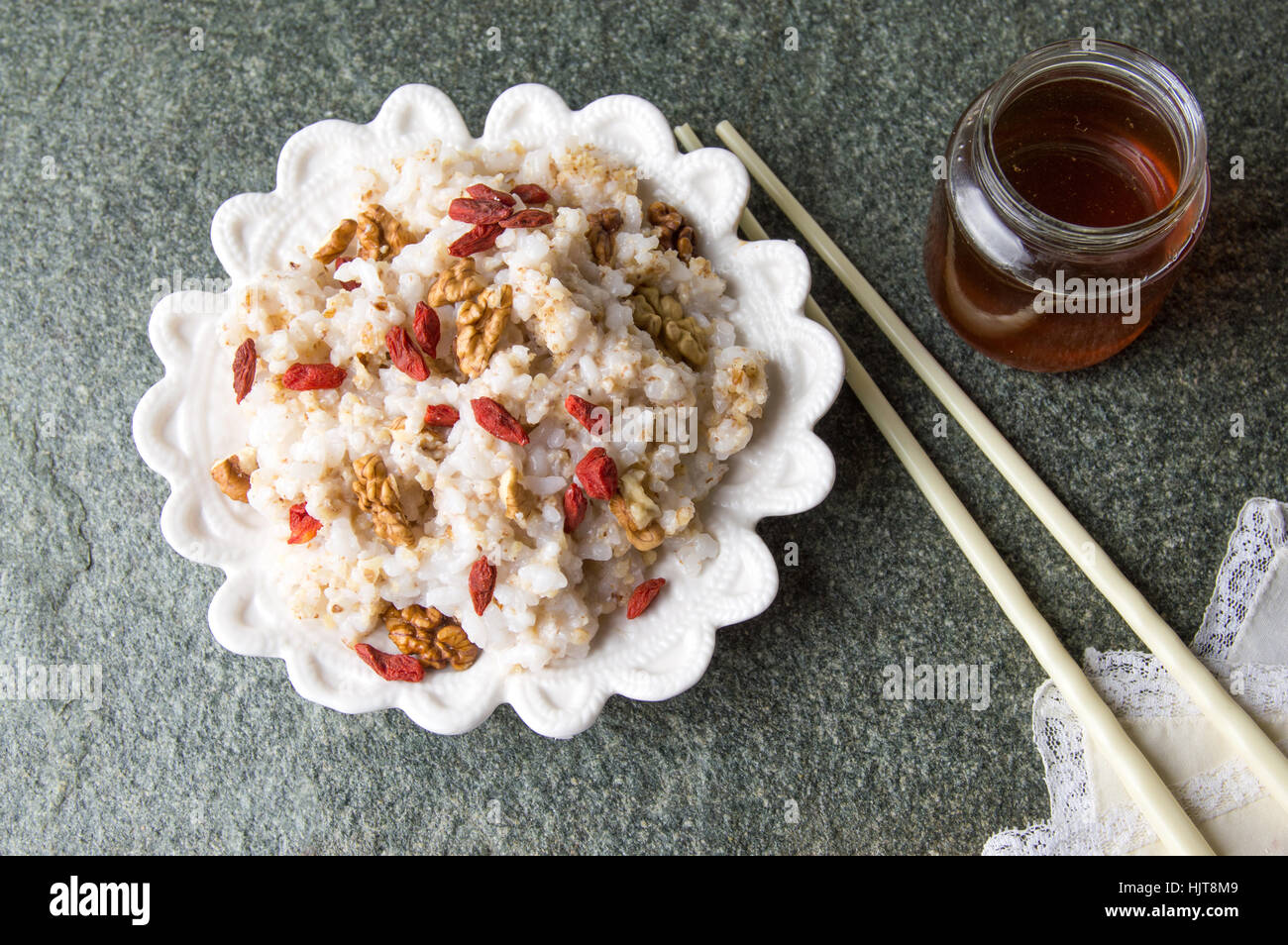 rice with walnuts and goji and chopsticks Stock Photo