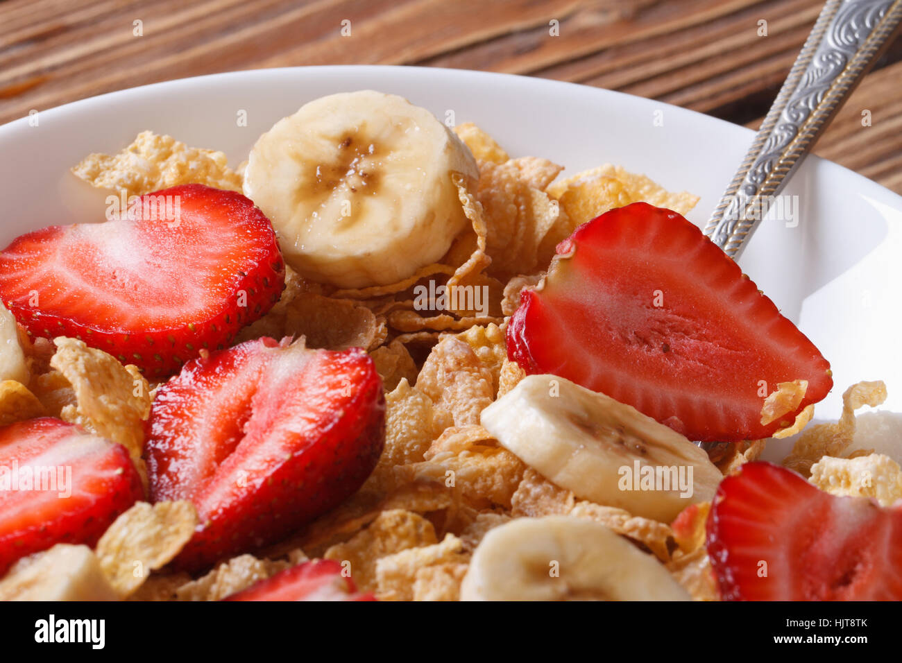 Breakfast muesli with fresh strawberries and banana close up on the table. horizontal Stock Photo