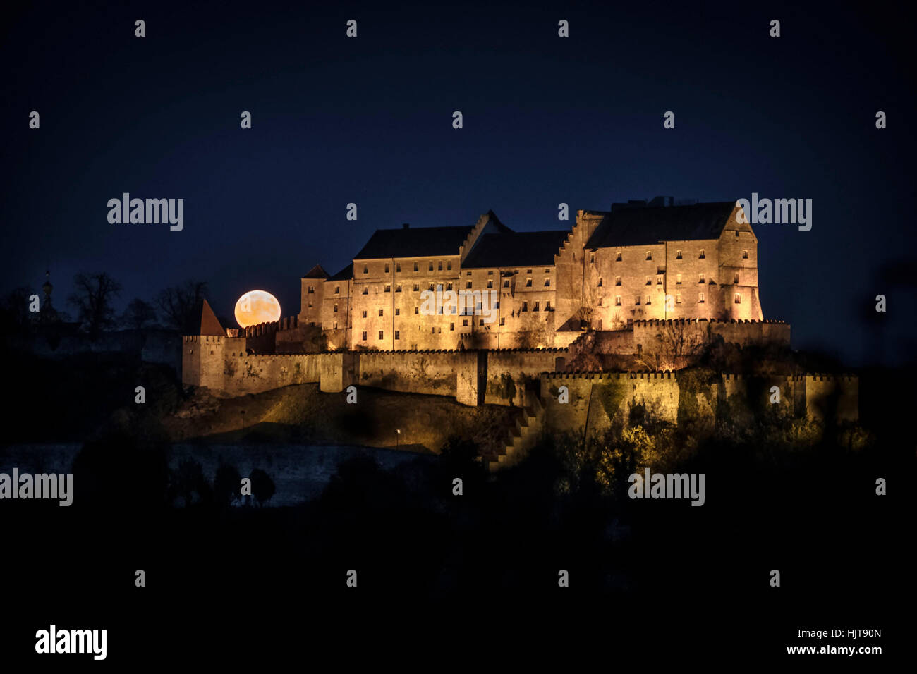 Germany, Burghausen, lighted castle in the night at full moon Stock Photo