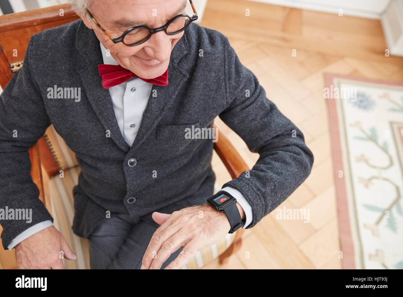 Senior man checking medical data on smartwatch Stock Photo