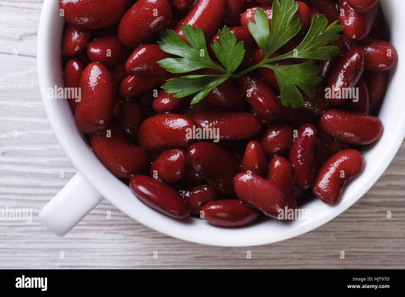 boiled red kidney beans in a white bowl on wooden background macro