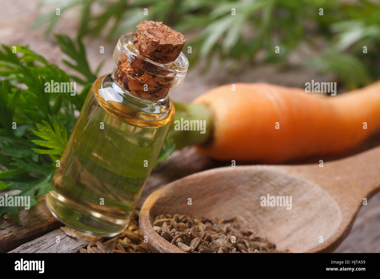 The essential oil of carrot seeds in a glass bottle closeup horizontal Stock Photo